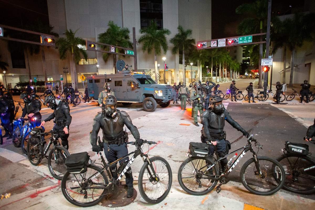 Police officers stand guard during protests over the Minneapolis arrest of George Floyd, who later died in police custody, in Downtown Miami, Florida, USA, 30 May 2020.