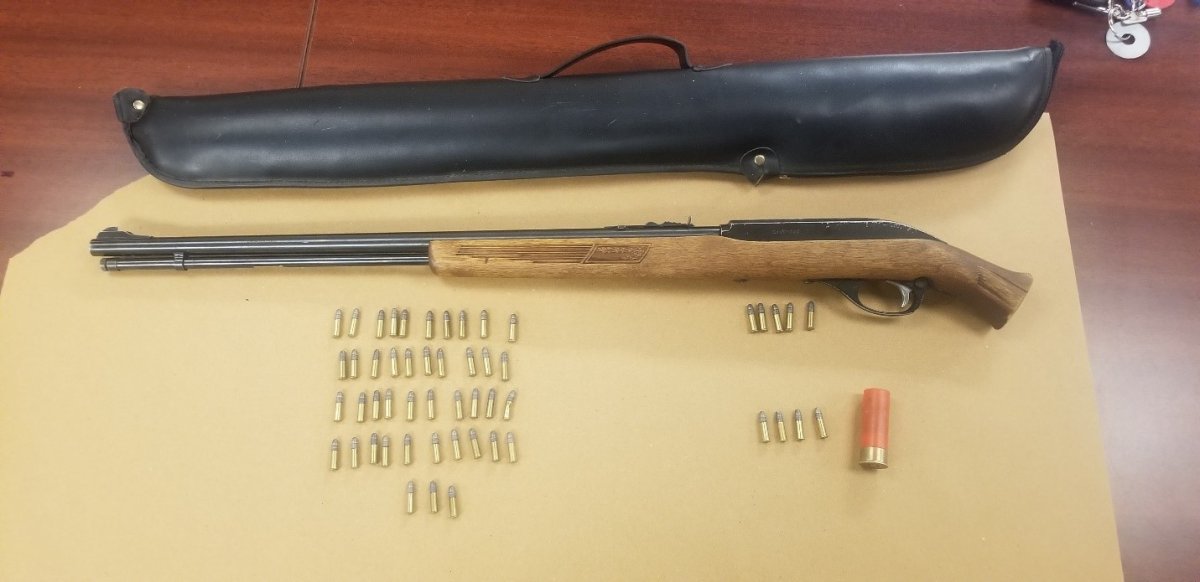 Officials say they seized a bolt action rifle with modified stock, 52 rounds of .22 caliber ammunition, and a 12 gauge shotgun shell.