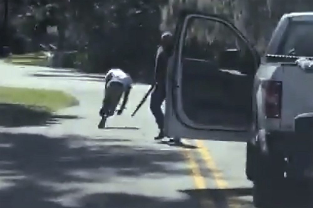 In this image from video posted on Twitter Tuesday, May 5, 2020, Ahmaud Arbery stumbles and falls to the ground after being shot as a man stands by holding a shotgun in a neighbourhood outside Brunswick, Ga., on Feb. 23, 2020.