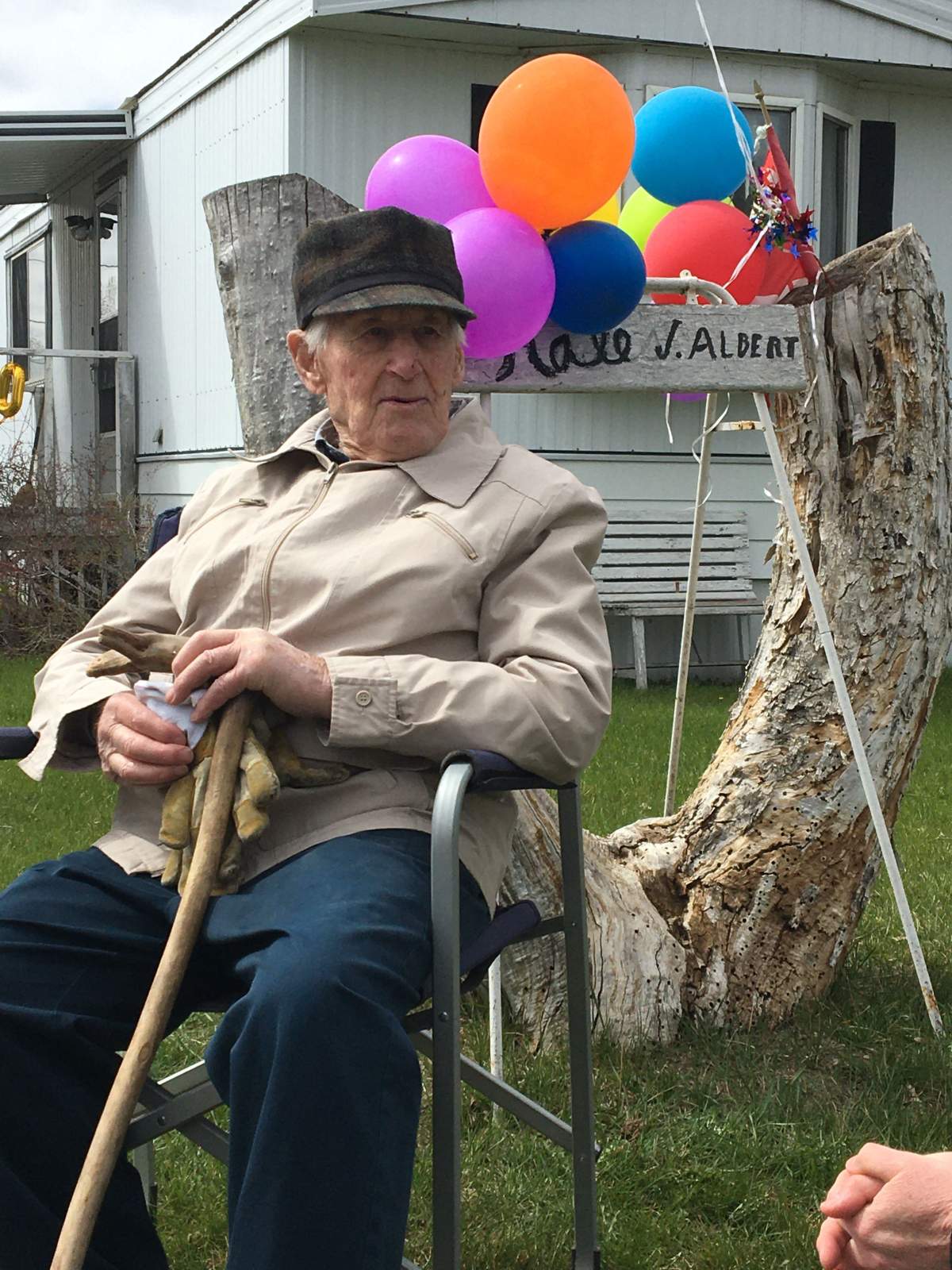 Albert Hale watches his 100th birthday parade roll by.