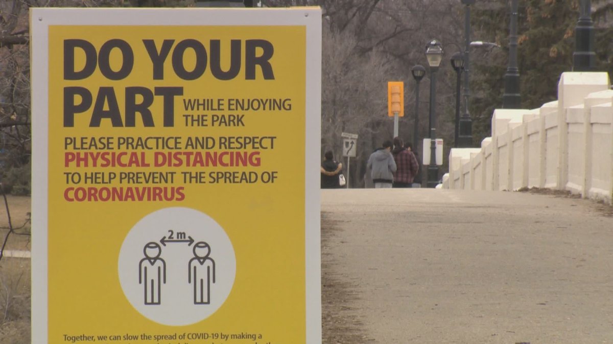 A sign at Assiniboine Park in Winnipeg reminding people of social distancing public health orders.