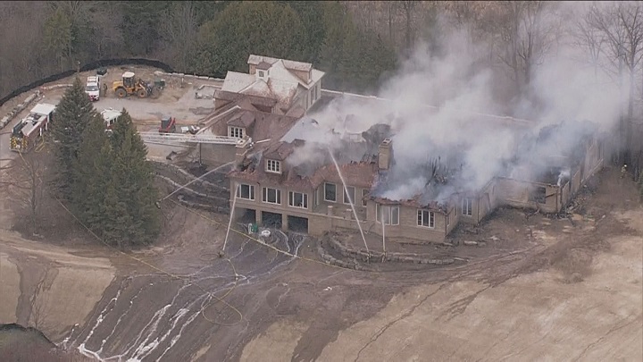 Firefighters on scene battling a fire at a home under construction in Aurora.