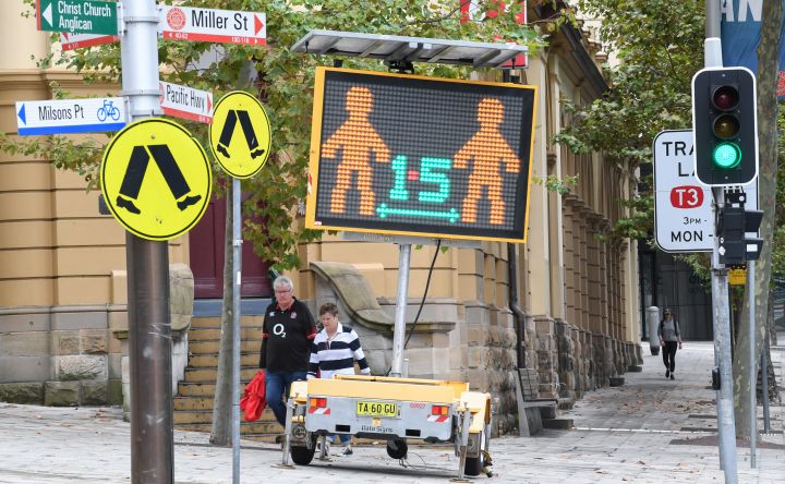 A digital sign warning people to stay at home, wash their hands and remain apart from the person next to them in North Sydney's CBD on April 10, 2020 in Sydney, Australia. 