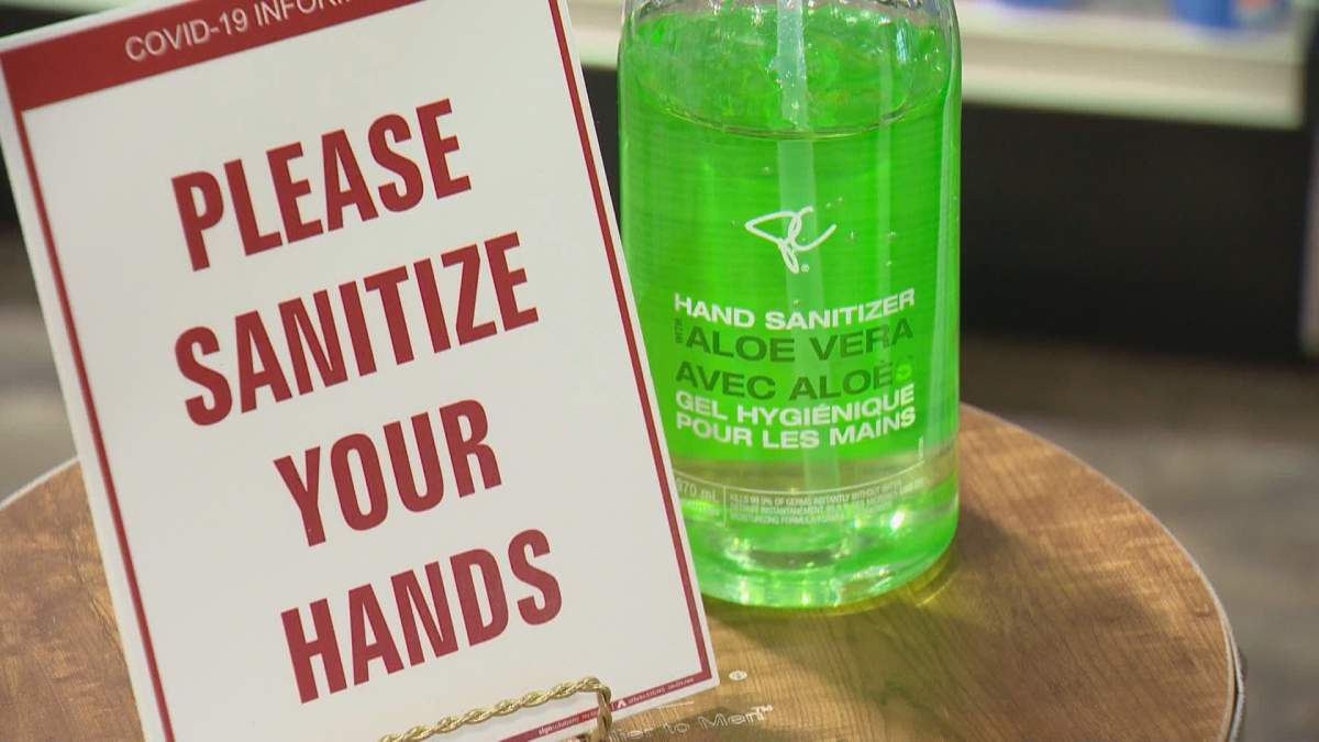 A sign asks clients to sanitize their hands at the store entrance of Beauty Depot in Regina.