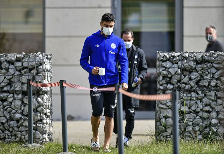 Schalke defender Ozan Kabak leaves the hotel, where his team stays in quarantine, with a face mask in Gelsenkirchen, Germany, Thursday, May 14, 2020. Bundesliga will now restart on May 16, 2020 when Borussia Dortmund will play the derby against FC Schalke 04 at home without spectators due to the coronavirus outbreak.