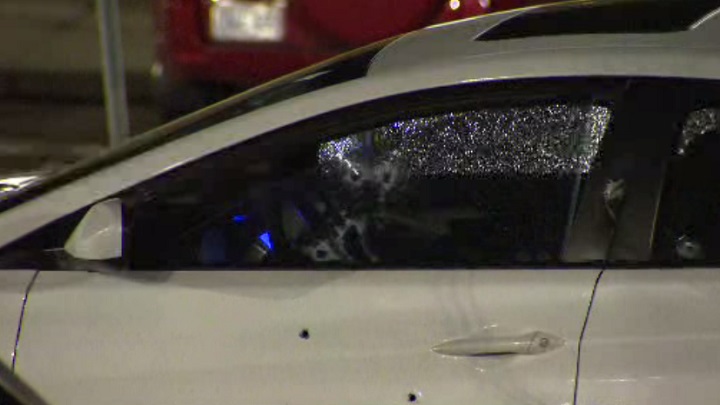 A car can be seen with multiple bullet holes.