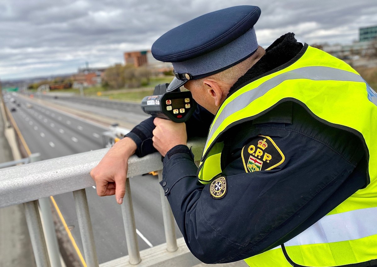 An Ontario Provincial Police officer checks the speeds of approaching motorists.
