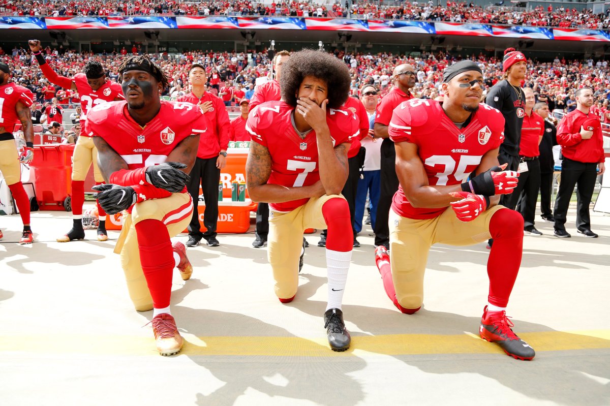 San Francisco 49ers quarterback Colin Kaepernick (C), linebacker Eli Harold (L), and free safety Eric Reid (R) take a knee during the U.S. national anthem before the NFL game between the Dallas Cowboys and the 49ers at Levi's Stadium in Santa Clara, Calif., in 2016. 