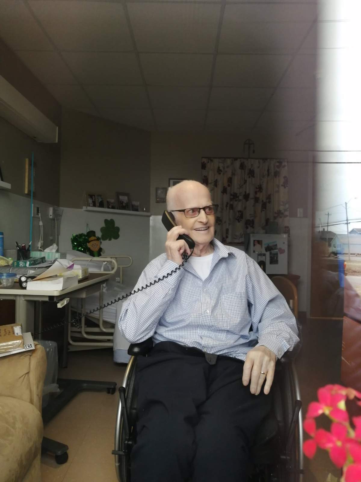 Greg MacNeil at the nursing home in Glace Bay, speaking with his son Allan.