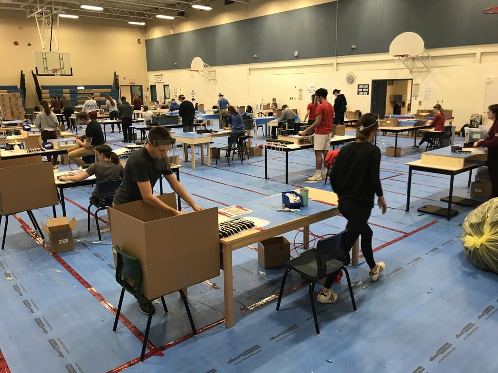 MacKenzie Atlantic workers on company’s production line at Prince Andrew High School in Dartmouth, N.S. are shown in this recent handout image. A small Nova Scotia company that retooled to make medical face shields for the province's health system says it is producing above its manufacturing target more than a month into the fledgling venture.
