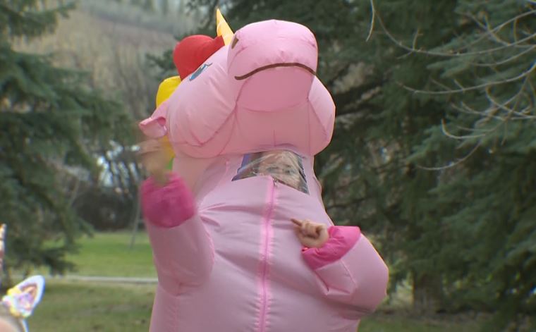Volunteers perform a Mother’s Day dance Wednesday outside the Bow View Manor care home in northwest Calgary.