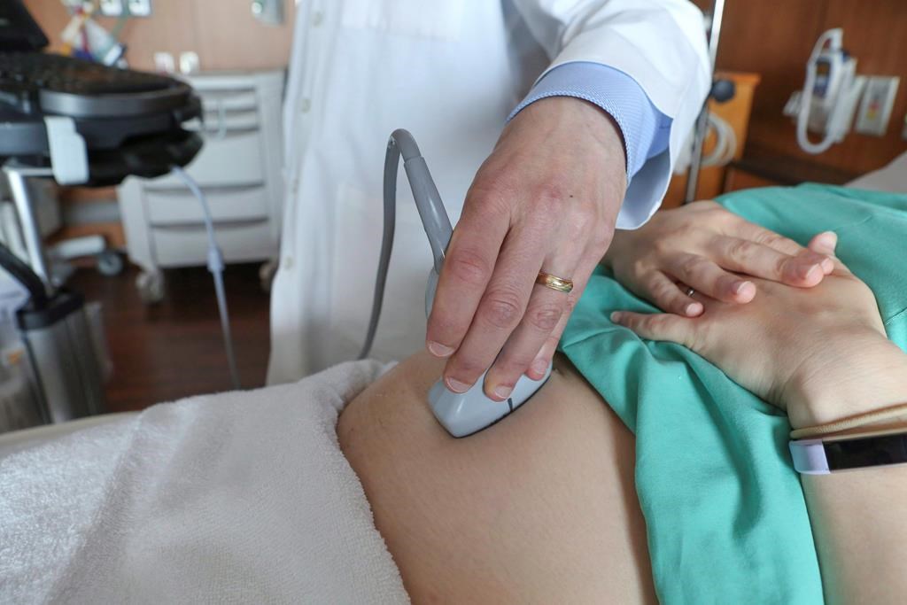 In this Aug. 7, 2018 photo, a doctor performs an ultrasound scan on a pregnant woman.