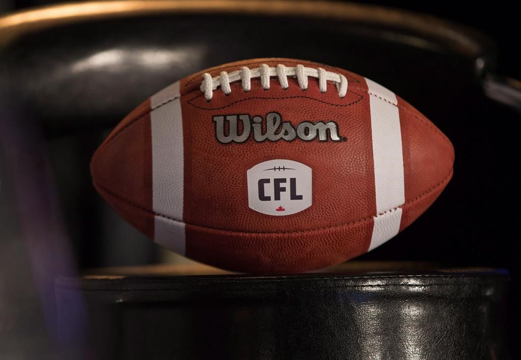 A football with the new CFL logo sits on a chair during a media conference in Winnipeg, Friday, Nov. 27, 2015.