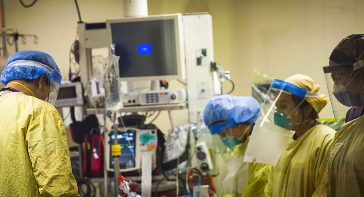 UHN Code Team leader, respiratory therapist and registered nurses pause in a moment of respect for the patient at the time of death.