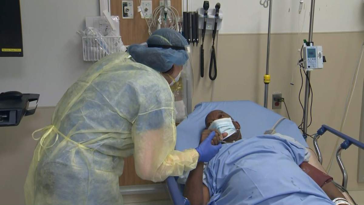 Dr. Susan Tory speaks with a COVID-19 patient at Toronto’s Humber river Hospital.