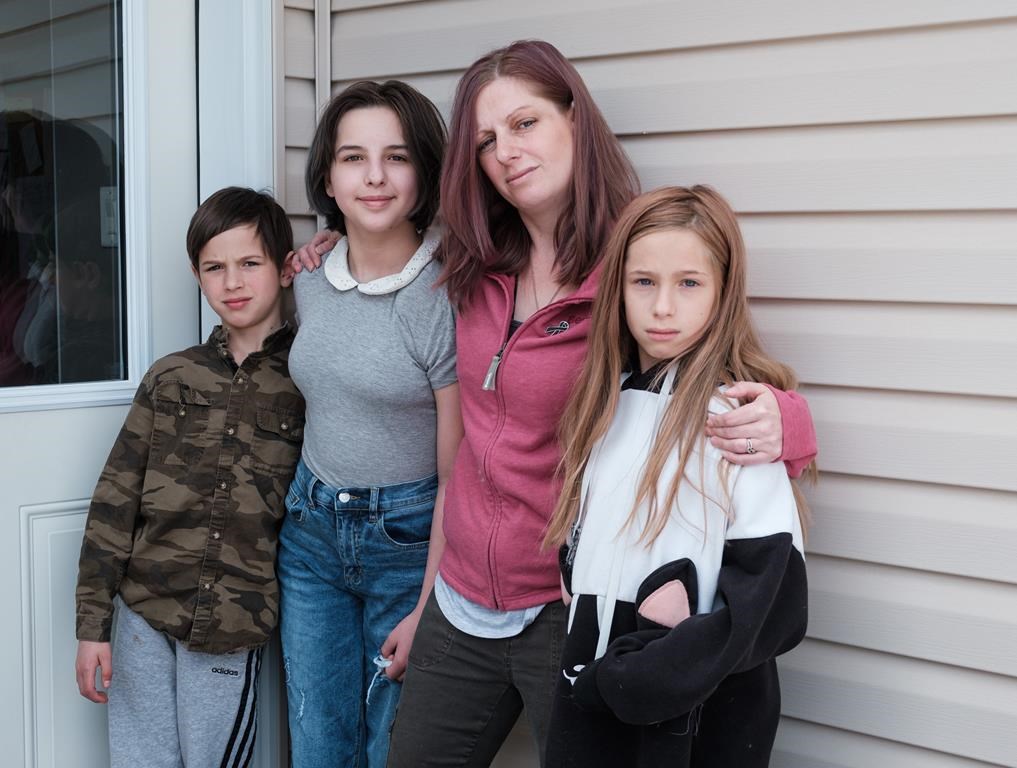 Sarah Sansom and her children, from left to right, Addison, 11, Ceirra, 13, and Daylen 8, pose for a portrait at their home in Nobleford, Alta., on Friday, May 29, 2020. Sarah’s husband, and the children’s father Jacob (Jake) Sansom and his uncle Morris Cardinal were found shot to death on a rural road in eastern Alberta in March 2020.