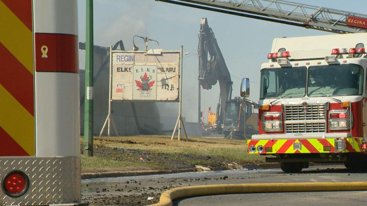 The Elks sign still stands as firefighters tackle the building fire on Sunday