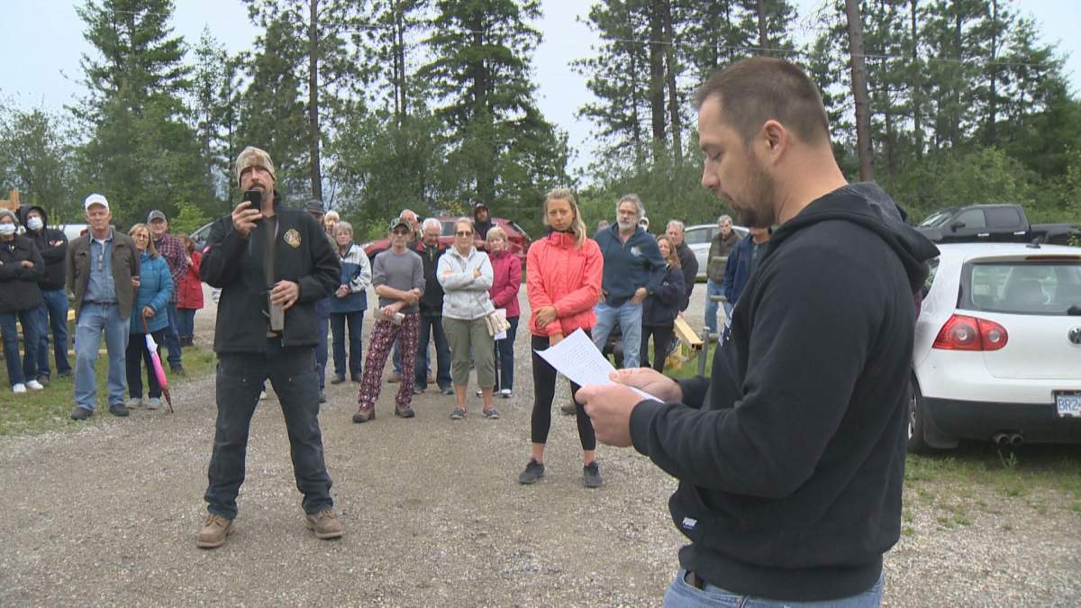 Suspended firefighter Robert Gajda reads a statement at a rally of North Westside residents. 