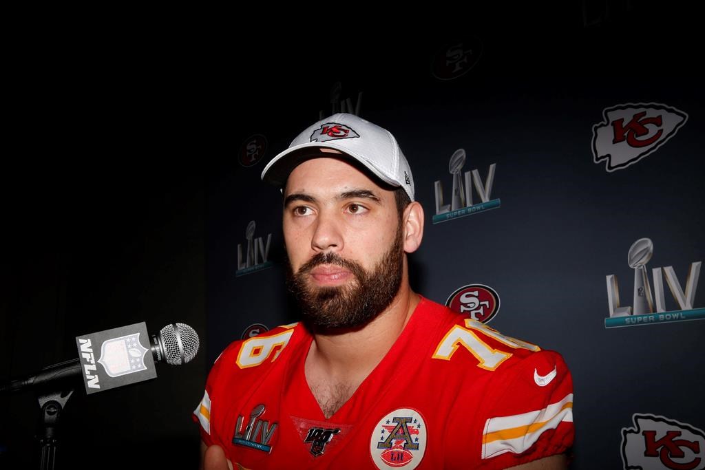 In this Wednesday, Jan. 29, 2020 photo, Kansas City Chiefs offensive guard Laurent Duvernay-Tardif (76) speaks during a news conference in Aventura, Fla., for the NFL Super Bowl 54 football game. Tardif is being recognized by the Hall of fame for his efforts in fighting COVID-19. Monday, Nov. 16, 2020. 