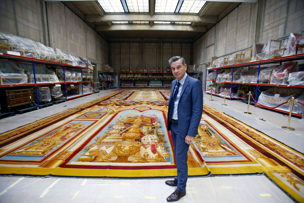 Director of national furniture Herve Lemoine poses in front of the fire-damaged carpet from the Notre Dame Cathedral on Sept. 12, 2019 in Paris, France.