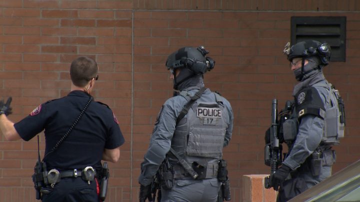 Calgary police investigate a report of gun fire at an apartment building in southwest Calgary on Wednesday. 