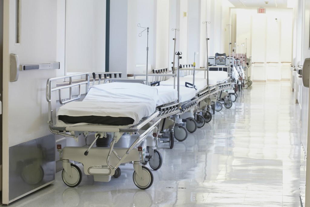 A file photo of hospital beds in a hallway.
