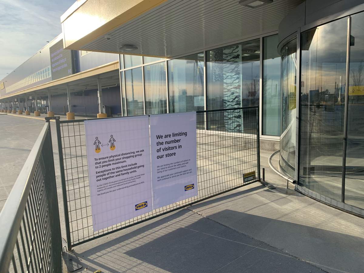 Signs outside the IKEA store Tuesday explaining some social distancing rules.