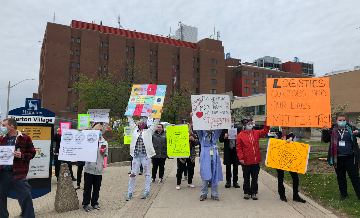 Hamilton Health Sciences employees demonstrated outside of Hamilton General Hospital during a shift change on Thursday, calling on the Ford government to expand the list of workers who will receive the pandemic pay raise.