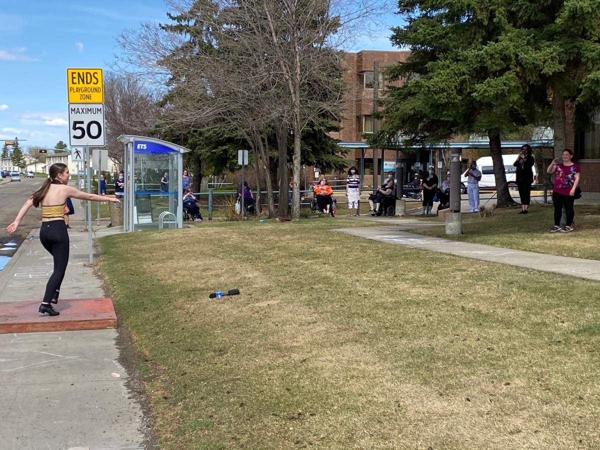A dancer performs outside for Edmonton seniors on May 6, 2020