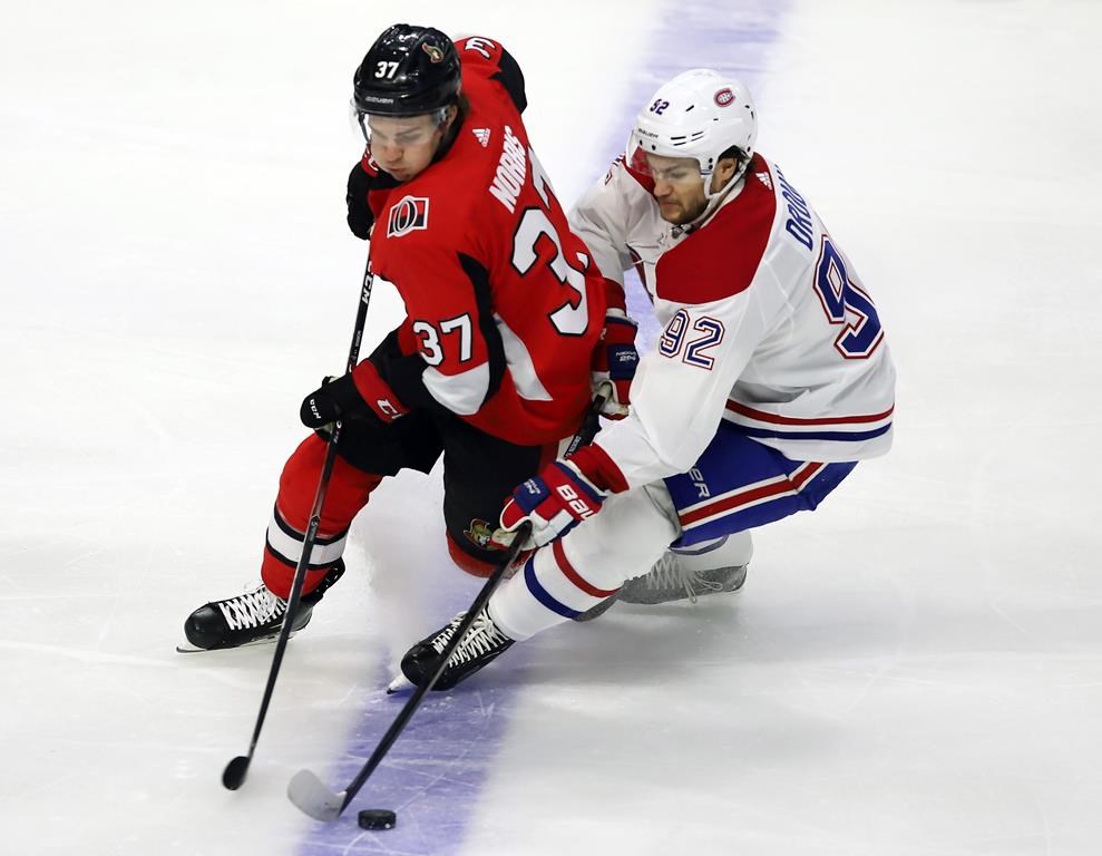 Ottawa Senators centre Josh Norris (37) and Montreal Canadiens left wing Jonathan Drouin (92) battle for the puck during first period NHL action in Ottawa on February 22, 2020.