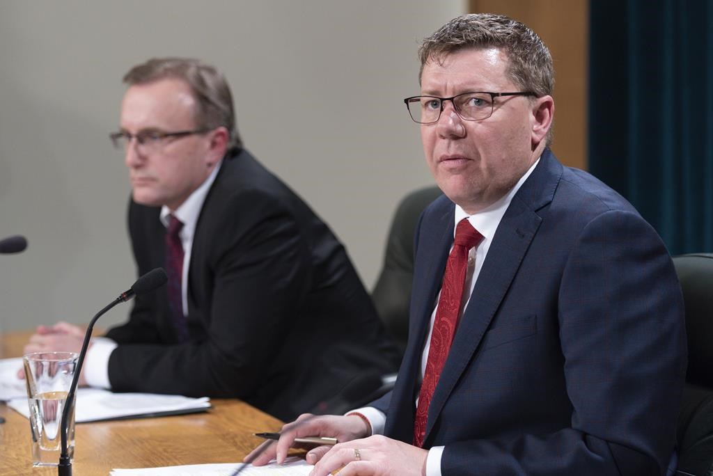 Scott Moe, premier of Saskatchewan, speaks while Jim Reiter, minister of health, looks on at a COVID-19 news update in Regina on March 18, 2020.