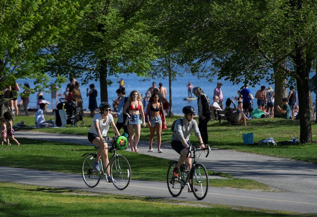 People enjoy the warm weather at Mooney's Bay Park in Ottawa, on Saturday, May 23, 2020, in the midst of the COVID-19 pandemic. THE CANADIAN PRESS/Justin Tang.