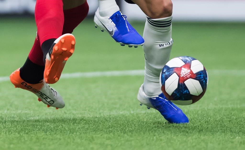 Toronto FC's Terrence Boyd, left, and Vancouver Whitecaps' Scott Sutter vie for the ball during the second half of an MLS soccer game in Vancouver on Friday May 31, 2019. THE CANADIAN PRESS/Darryl Dyck.