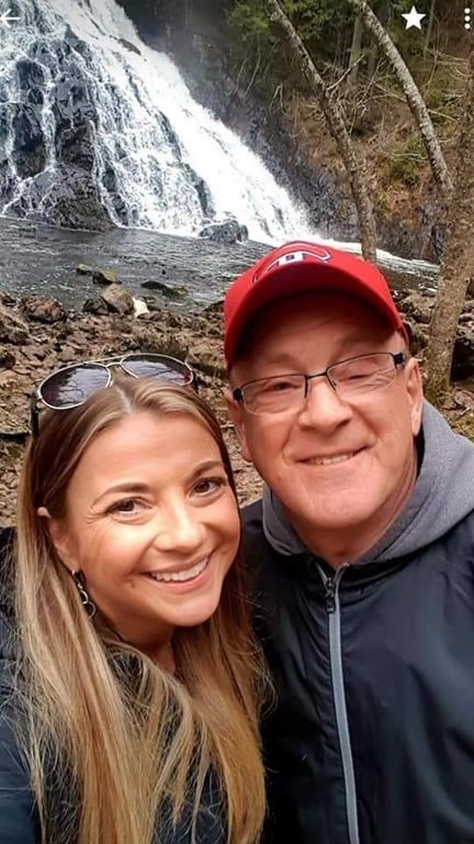 Kelly Marshall, left, and her father Rick Cameron pose for a selfie at a waterfall in Nova Scotia in an undated handout photo.