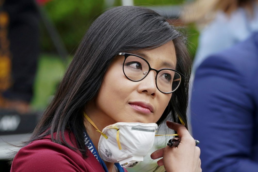 CBS News White House correspondent Weijia Jiang pulls back her protective face mask after asking U.S. President Donald Trump a question at the White House on May 11, 2020.
