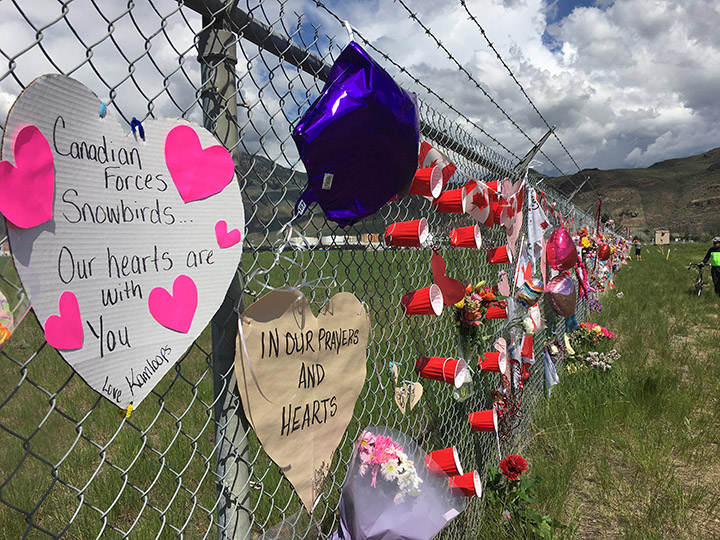 Canadian memorabilia attached to the fence at Kamloops Airport following the death of Snowbirds Captain Jennifer Casey. An online petition is asking the city to change the road to Capt. J. Casey Memorial Way.