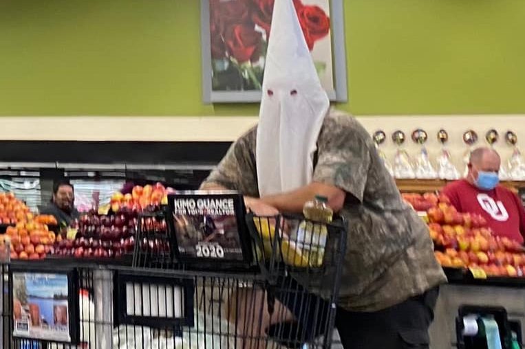 A shopper wears a KKK hood to a grocery store in Santee, Calif., on May 2, 2020.