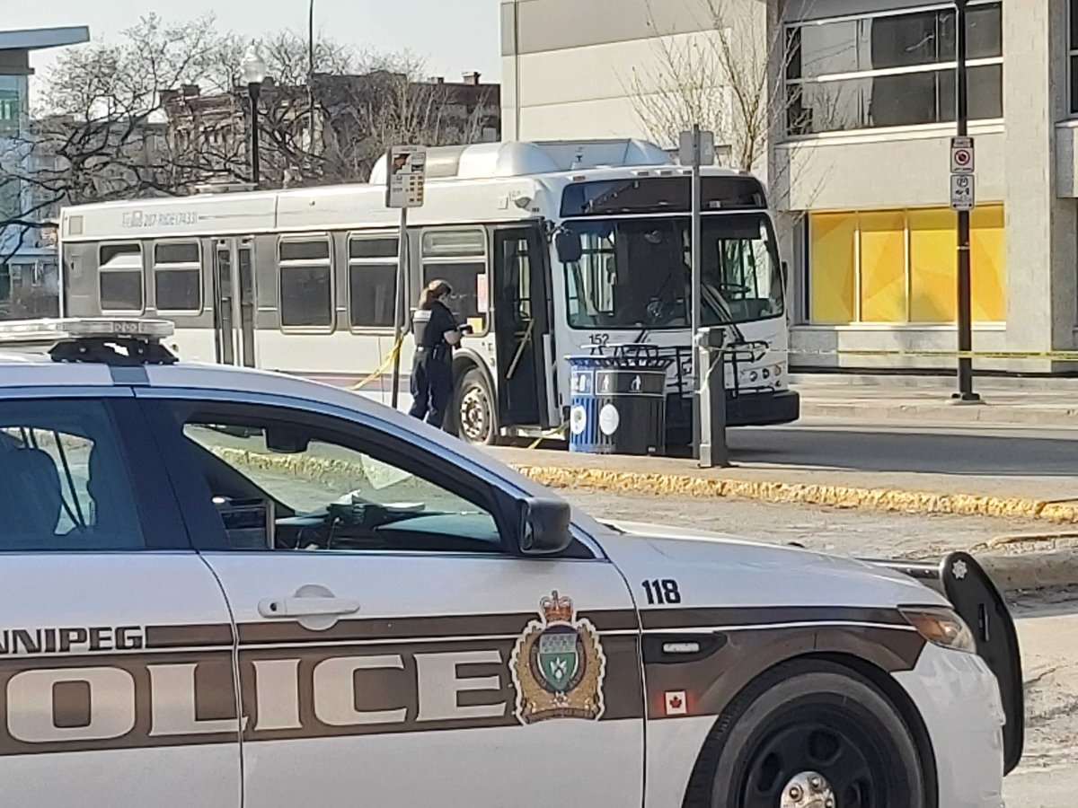 A police officer investigates a bus near the corner of Main and Pacific Tuesday evening.