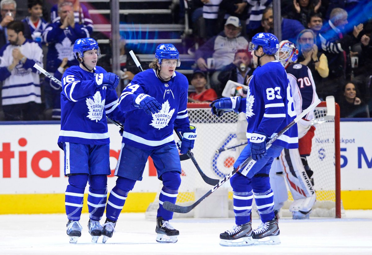 Toronto Maple Leafs right wing Kasperi Kapanen, centre, celebrates his goal against the Columbus Blue Jackets with teammates Mitchell Marner, left, and Cody Ceci during first period NHL action in Toronto on Monday, Oct. 21, 2019.