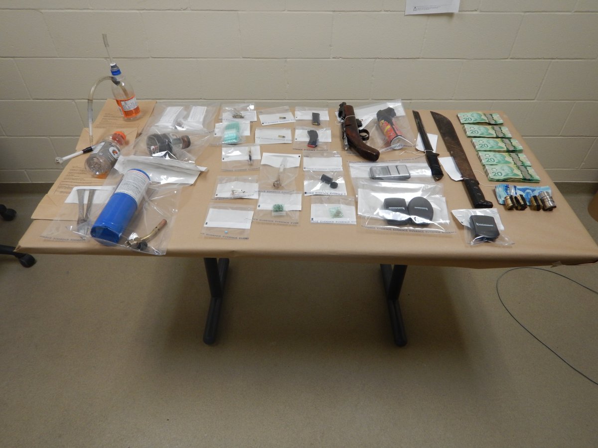 Drugs, weapons, and cash seized by Mounties from a home in Moose Lake.