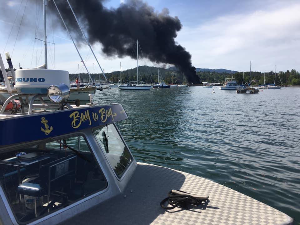 A plume of smoke is seen coming from the North Saanich Marina. One person has died and two people have been taken to hospital with non-life threatening injuries after an explosion and fire.