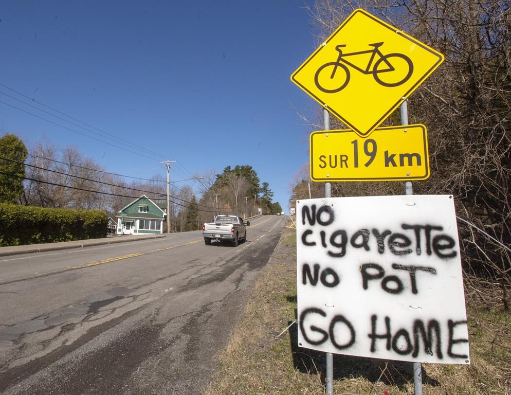 A sign advises non-residents at the entry to the Mohawk territory of Kanasateke to turn around as the community tightens access to the reserve amid the COVID-19 pandemic Monday, April 20, 2020 in Oka, Que. The mayor of Oka, Que., says members of the neighbouring Mohawk community of Kanesatake are blocking access to a provincial park that was supposed to partially reopen today.