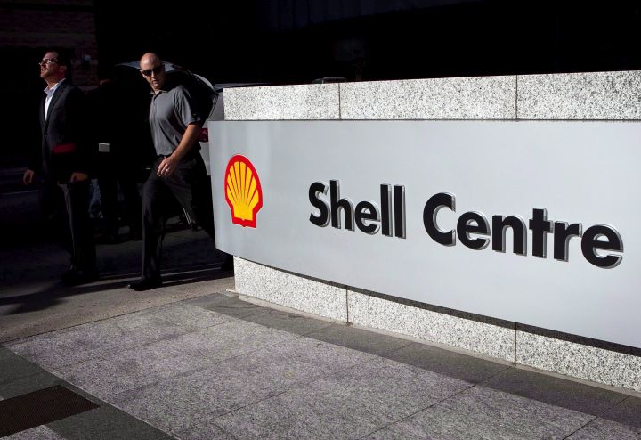 Pedestrians walk past Shell Canada's headquarters during a news conference in Calgary, Thursday, Aug. 26, 2010. 