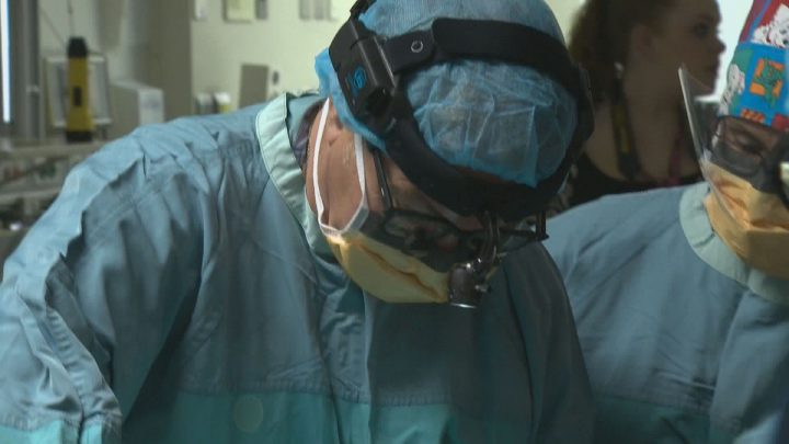 File footage shows a surgeon at work. 