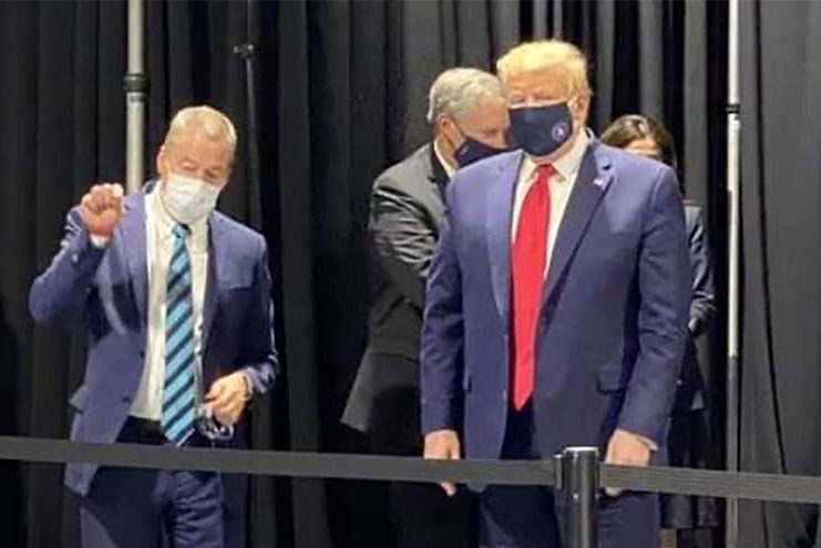U.S. President Donald Trump, right, is shown wearing a mask at a Ford facility in Ypsilanti, Mich., on May 21, 2020.