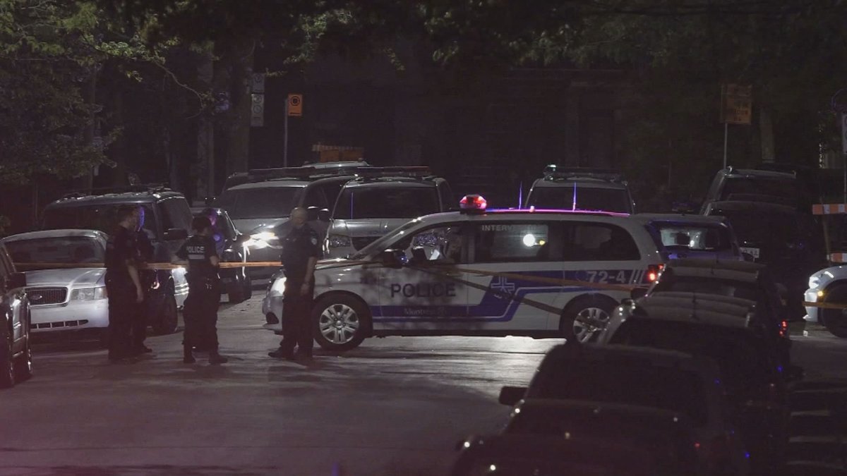 Montreal police officers at the scene after a reported shooting involving a taxi in the Sud-Ouest borough late on May 26, 2020.