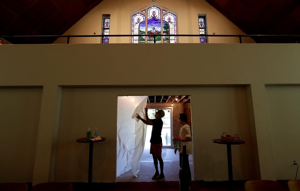 Alamo Heights Baptist Church pastor Bobby Contreras, left, and his wife Hannah, work to clean, sanitize and prepare the church for services this Sunday, in San Antonio, Texas, May 6, 2020.