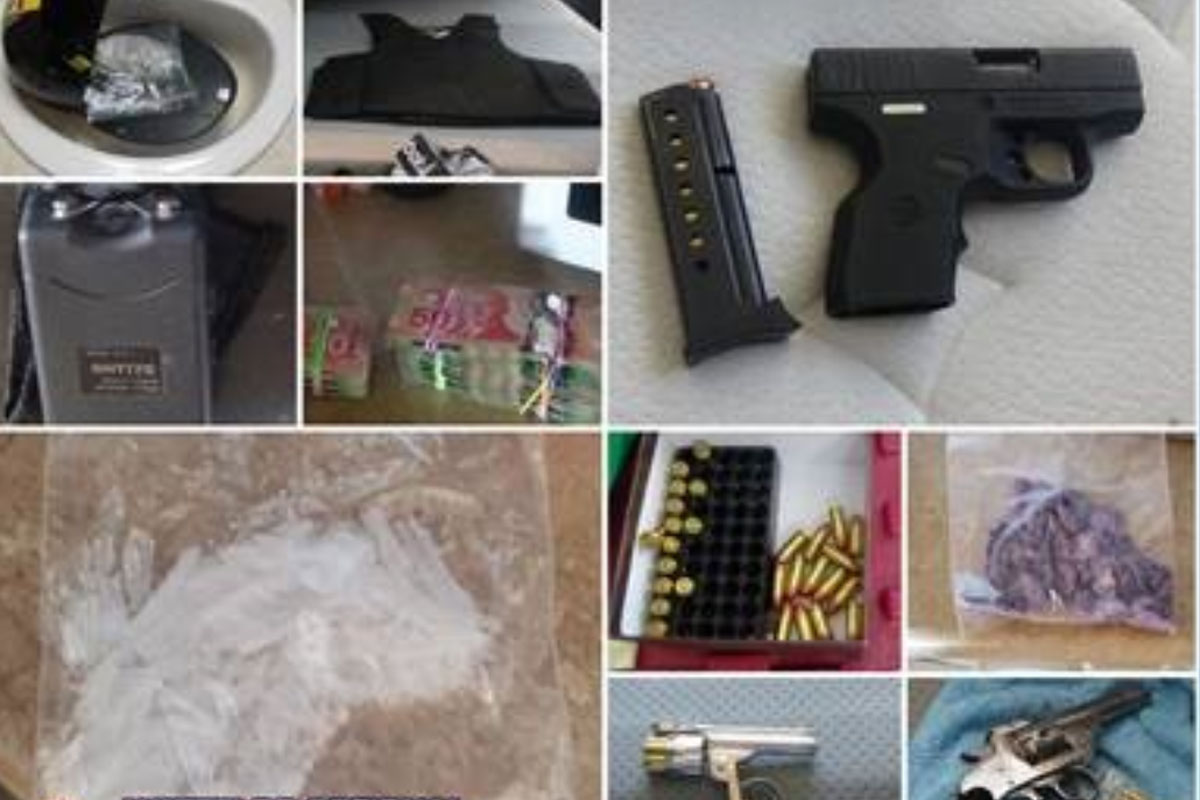Police allegedly seized guns, weapons and cash while searching a Kitchener home.