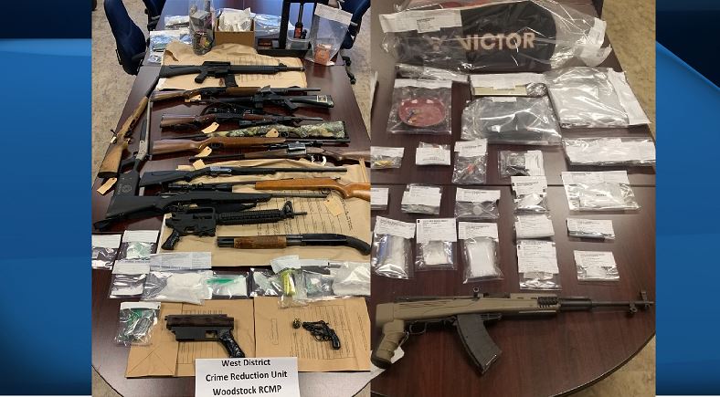 Police say 17 weapons and drugs were seized as a result of the two search warrants being executed. 