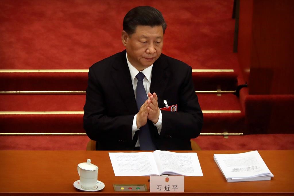 Chinese President Xi Jinping applauds during the opening session of China's National People's Congress (NPC) at the Great Hall of the People in Beijing, Friday, May 22, 2020.